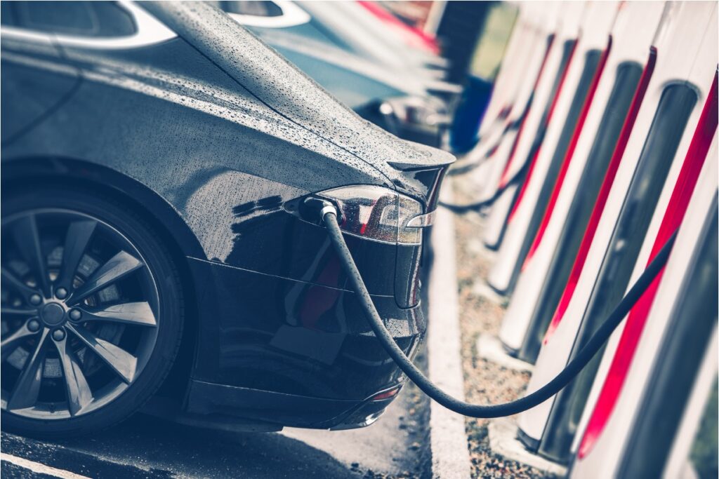 Tesla car charging at a fast-charging station