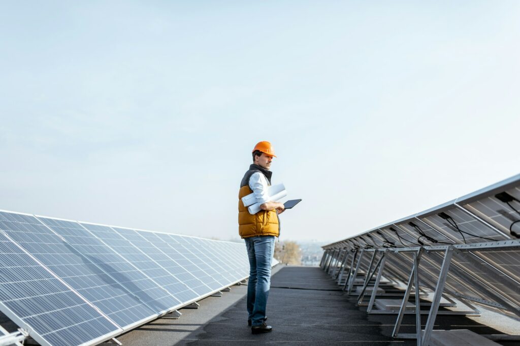 Engineer standing among solar panels